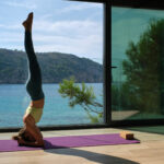 woman practicing yoga on mat in headstand 2023 08 15 20 36 11 utc